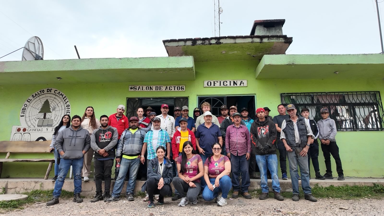 Group portrait outside SALON DE ACTOS at Ejido El Salto de Camellones, Durango, Mexico, October 2025